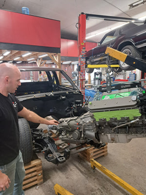 Mechanic working on a car engine in a garage