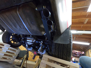 Close-up of Firebird's exhaust system in a garage setting
