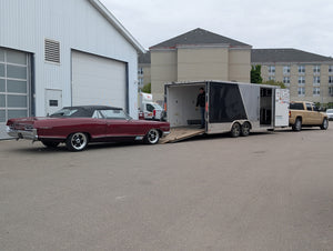 1966 Parisienne being loaded onto a trailer in an industrial area