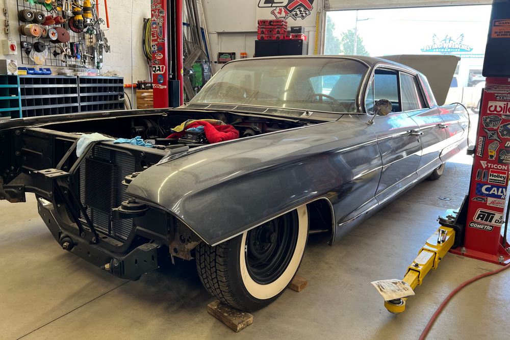 Vintage car in a garage with tools and equipment around