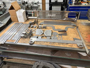 Chassis project with cut pieces on a workbench in a workshop.