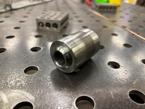 Metal cylindrical component on a perforated metal surface