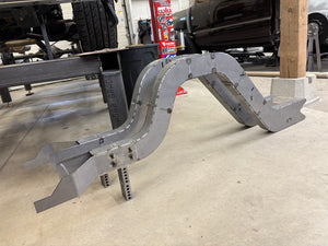 Assembled chassis rails sitting next to chassis table ready for welding