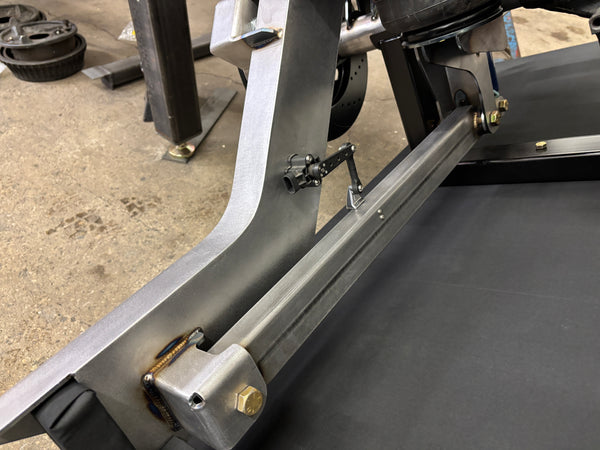 Close-up of a accuair height sensor attached to 4 link arm in chassis assembly