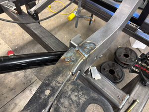 Metal frame structure with bolts and hardware on a concrete floor