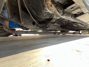 Close-up of a vehicle's undercarriage on a road