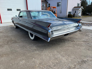 Vintage Cadillac parked in front of IssyFab