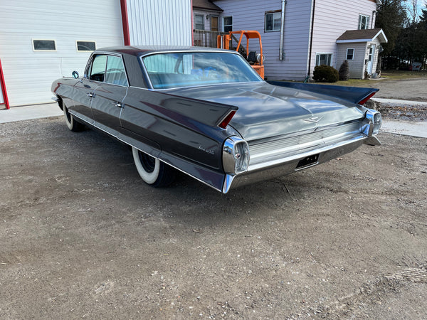 Vintage Cadillac parked in front of IssyFab