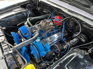 Car engine with blue components and visible wiring