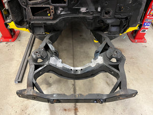 Car undercarriage with suspension components on a concrete floor