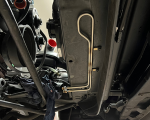 Close-up of a car's undercarriage with visible suspension components.