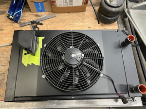 Radiator with a fan on a workbench in a garage setting