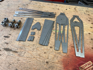Collection of metal components on a wooden workbench