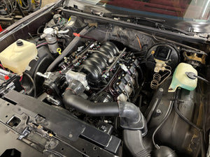 Car engine compartment with various components visible