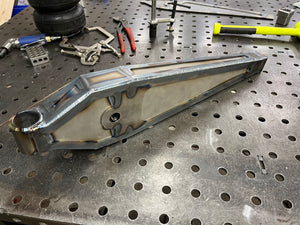 Metal component on a perforated metal surface with tools in the background