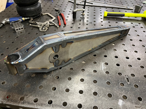 Metal component on a perforated metal surface with tools in the background