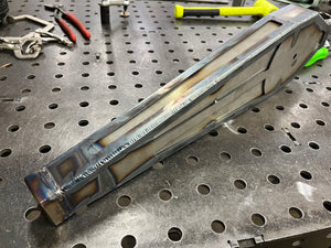 Metal component on a perforated metal surface with tools in the background