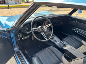 Interior of a classic 1969 Corvette with a steering wheel and dashboard.