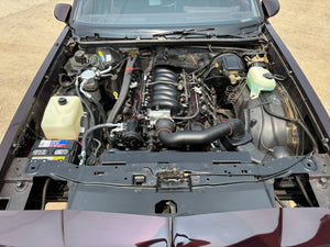 Car engine compartment with various components visible