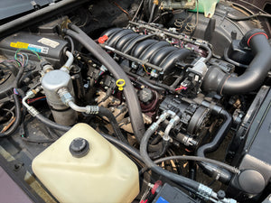 Car engine with various components and hoses.