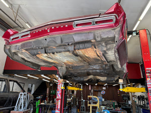 Car body panel on a lift in a workshop