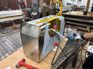 Stainless fuel tank assembly being welded while back purged sitting on bench