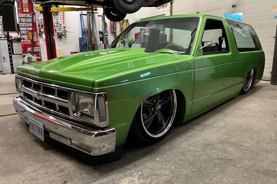 Green 1991 Jimmy in a garage setting