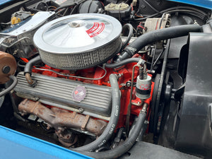 Close-up of a car engine with visible brand logos.