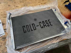 Metal radiator with 'Cold Case' branding on a wooden surface