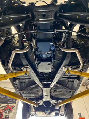 Close-up view of a vehicle's undercarriage with visible suspension components.