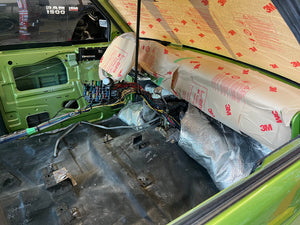 Car interior with exposed wiring and 3M packaging