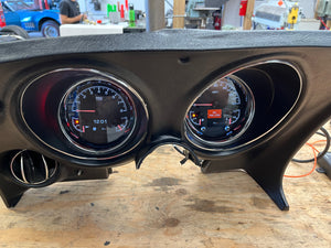 Car dashboard with dakota digital gauges on a wooden surface