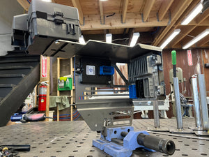 Metalworking machine in a workshop setting with tools and equipment around