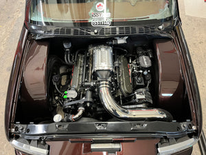 Engine of a car with visible branding on a concrete floor