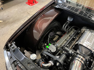 Car engine with open hood on a concrete floor