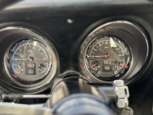 Close-up of a car's instrument cluster with two gauges.