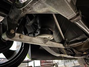 Close-up of a vehicle's undercarriage with suspension components.