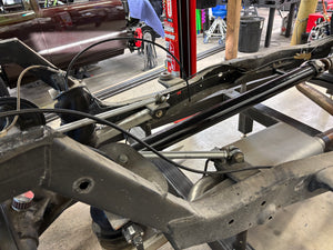 Close-up of a vehicle suspension system with a workshop background